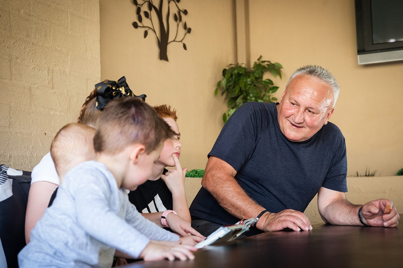 man reading to grandchildren